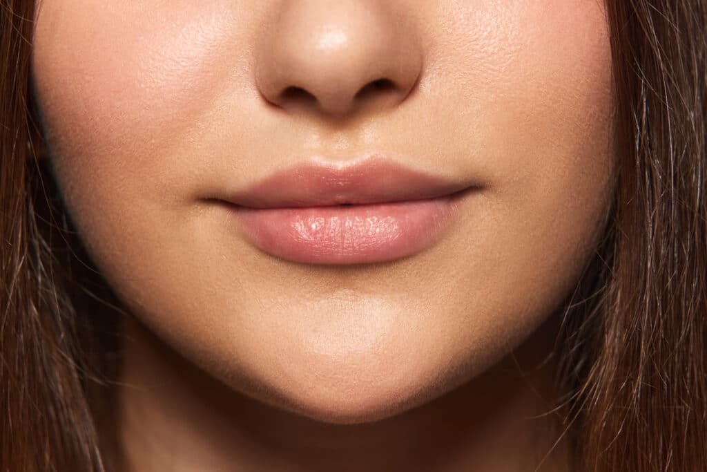 Close up of a female patient's full lips after getting autologous fat transfer for natural volume. Close up of a female patient's full lips after getting autologous fat transfer for natural volume.